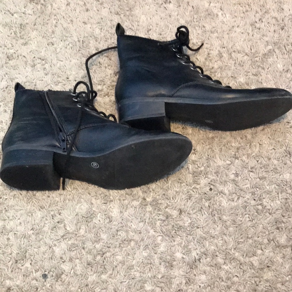 Black high heeled boots with zippers and shoelaces
